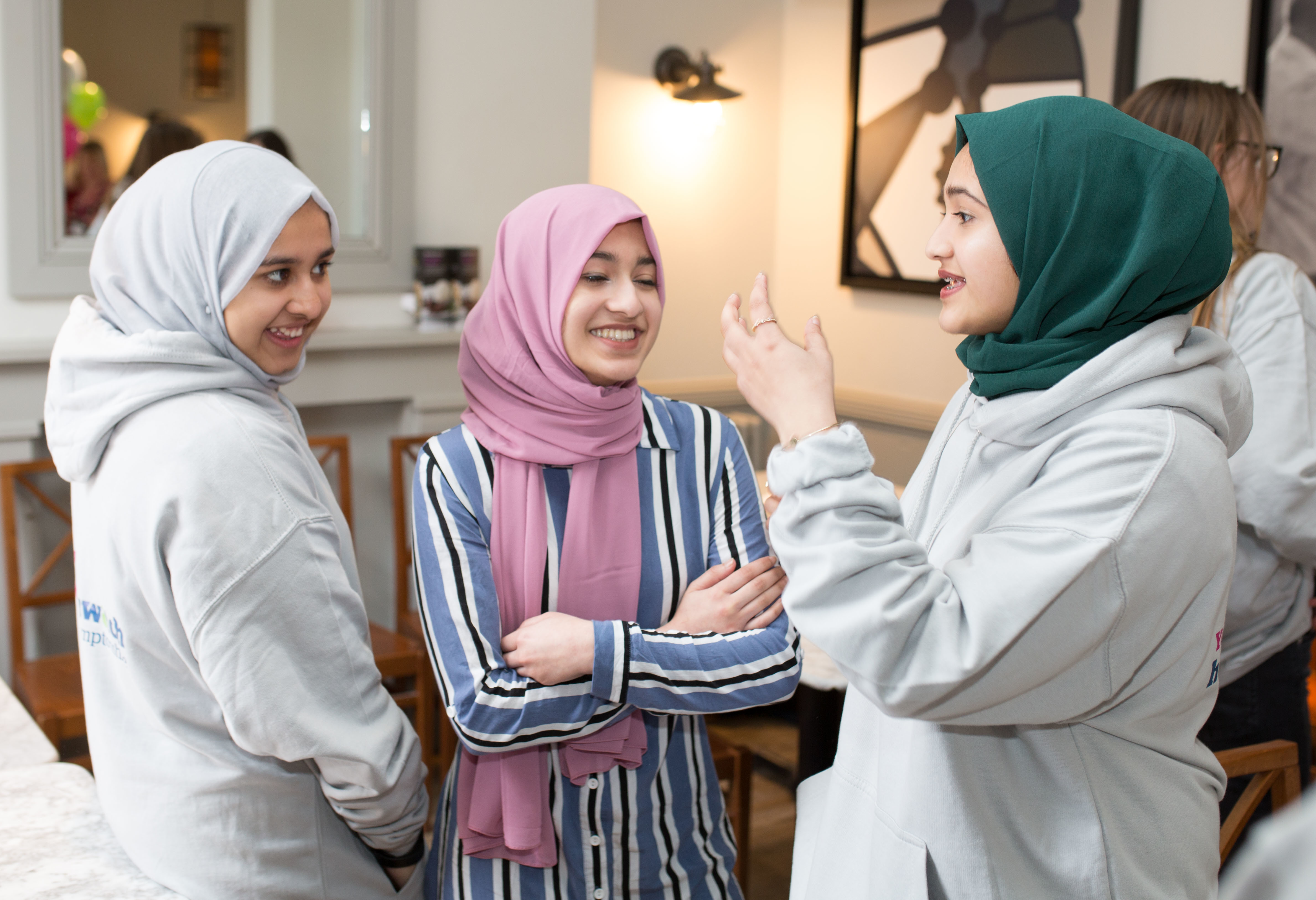 Three young women talking.