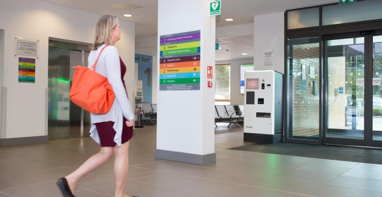 Woman walking in hospital.