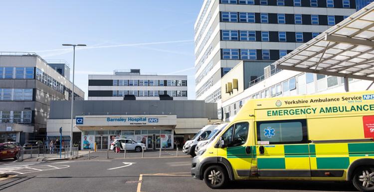 An ambulance outside a large hospital building