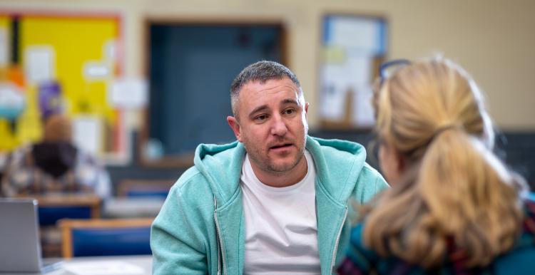 A man talking to a woman