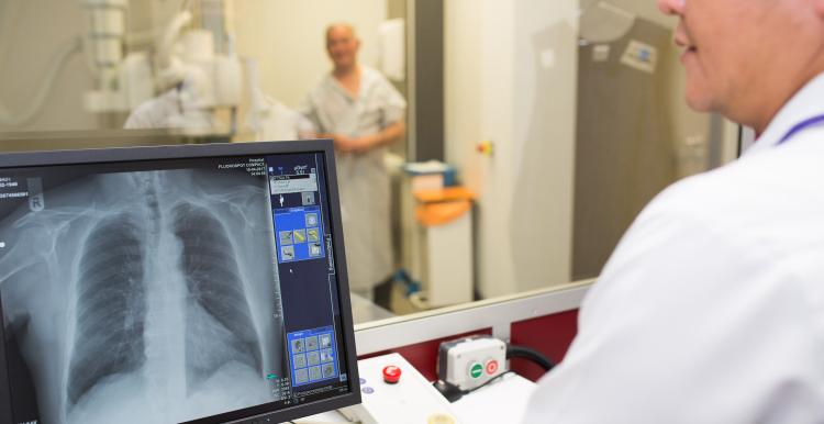 A medical professional looking at a patient's x-ray.