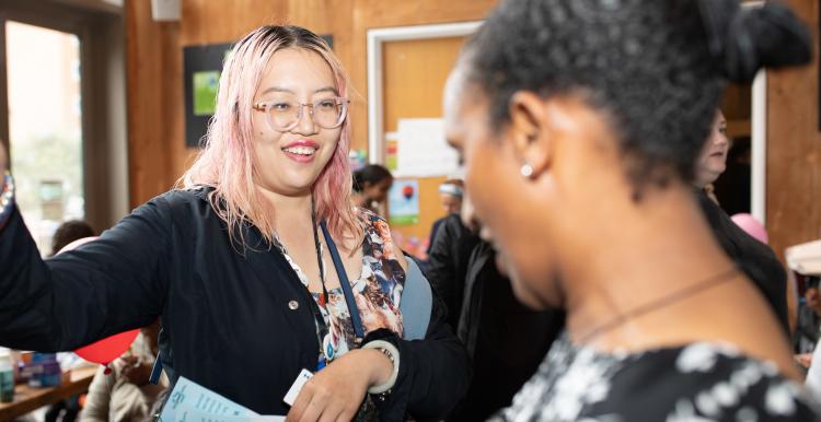 Two women talking at an event.