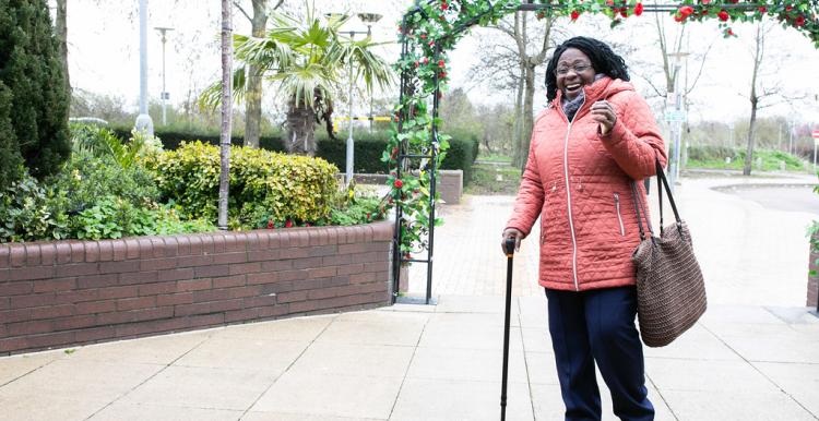 Older adult walking in cold weather.