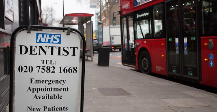 a street sign for a nhs dentist