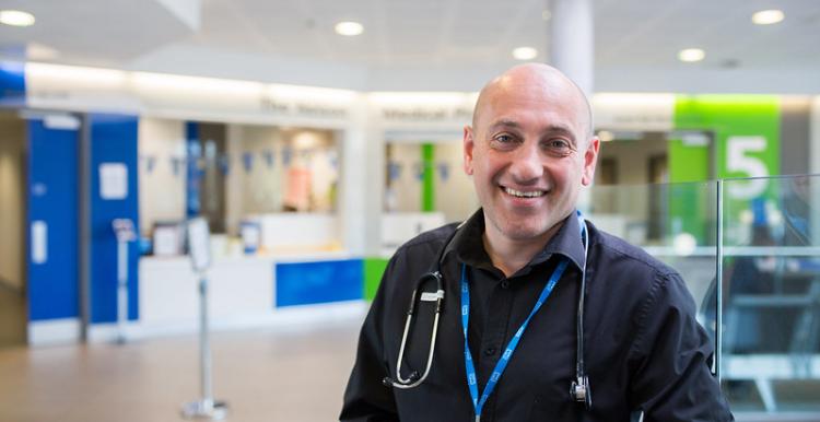 A doctor smiling in a hospital