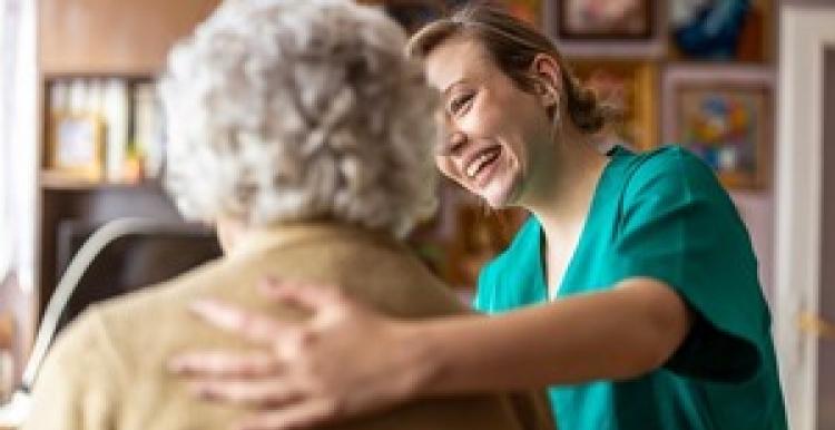 Social care worker helping woman.