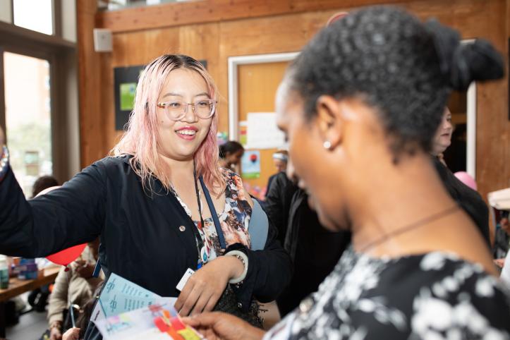 Two women talking at an event.