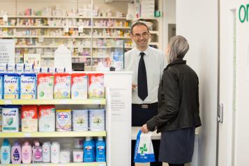 Pharmacist assisting customer.