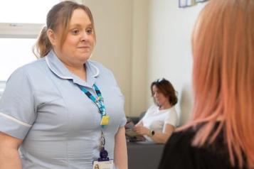 Two women talking in a healthcare setting