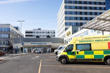 An ambulance outside a large hospital building