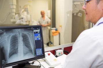 A medical professional looking at a patient's x-ray.