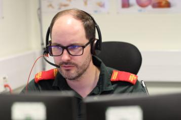 Ambulance worker taking calls with a headset. 