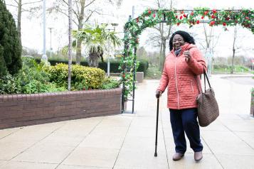 Older adult walking in cold weather.