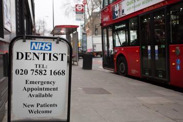 a street sign for a nhs dentist