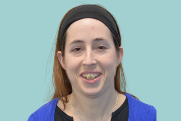 A photo of a Healthwatch volunteer against a blue backdrop.