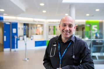 A doctor smiling in a hospital