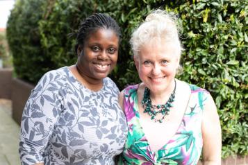 Two ladies standing together smiling