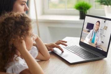 A lady and child looking at the computer