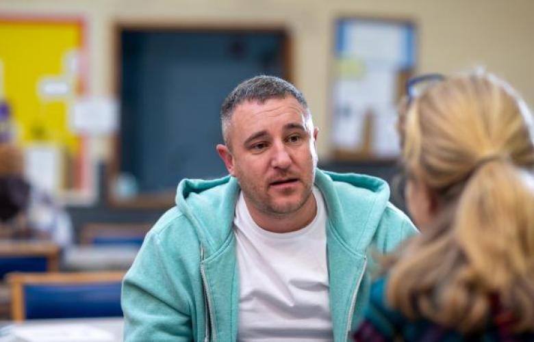 A man talking to a woman