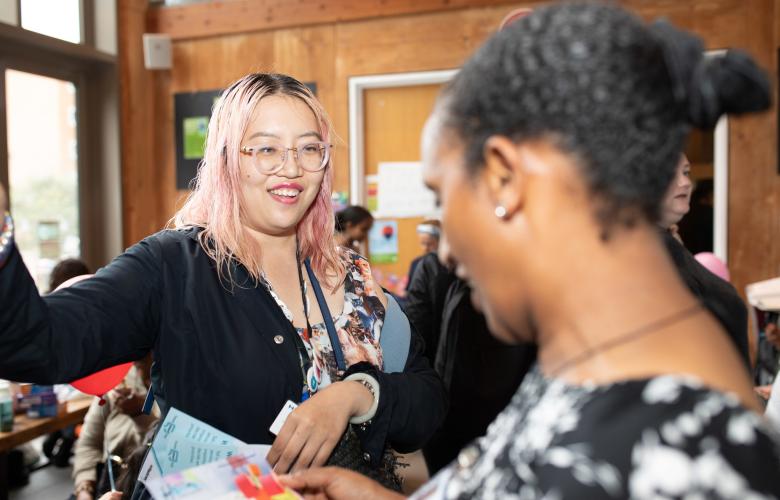 Two women talking at an event.