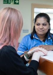 A woman speaking to a healthcare professional.