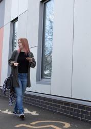 Two women walking and talking together.